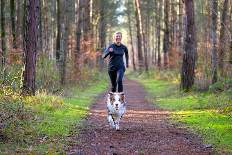 Woman running with dog.